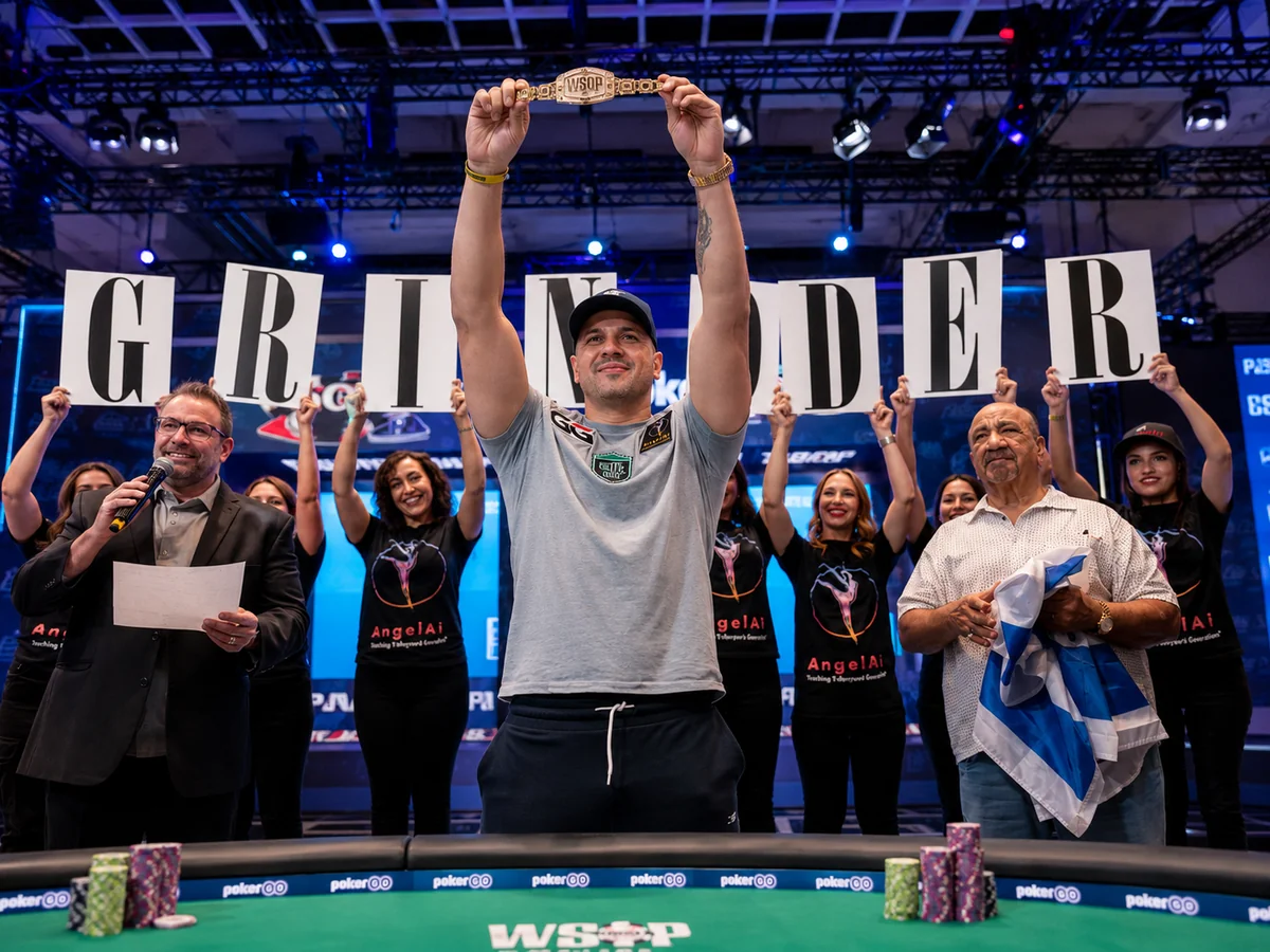 Michael Mizrachi lifts his ninth WSOP bracelet as friends and family hold up letters spelling GRINDER