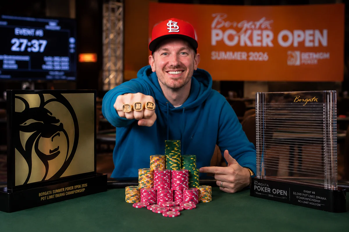 Brandon Mueller shows off his rings alongside the Event #8 trophy at the Borgata Summer Poker Open