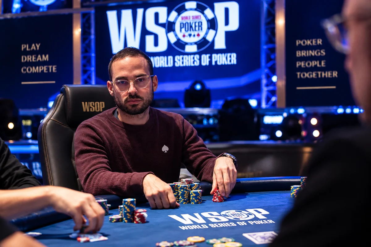 A player deep in a World Series of Poker event, chips stacked in front of him